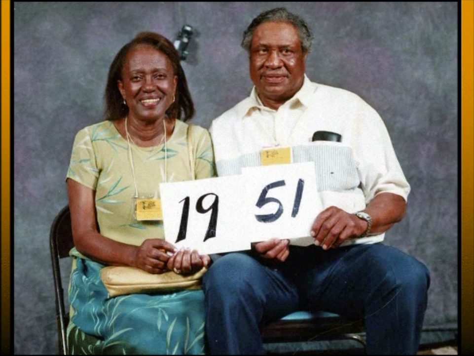 Members of the Class of 1951 hold up their class-year card at the 1999 Blevins reunion.