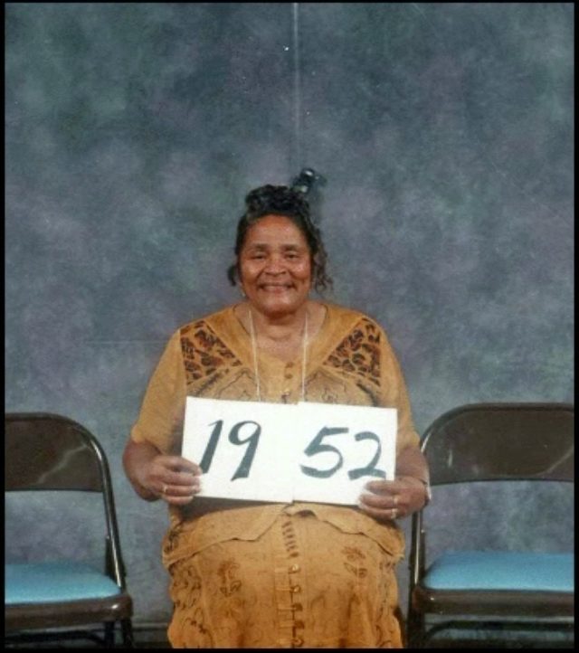 Members of the Class of 1952 hold up their class-year card at the 1999 Blevins reunion.
