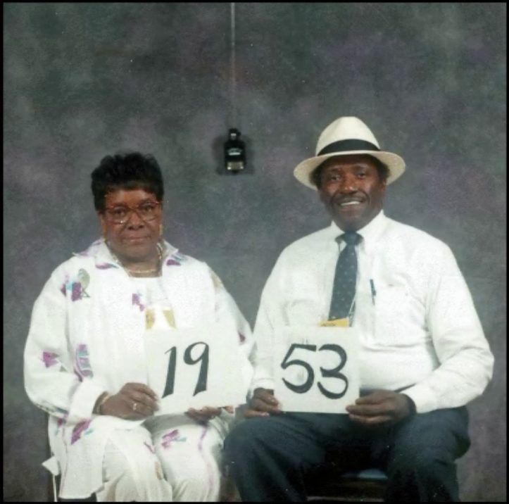 Members of the Class of 1953 hold up their class-year card at the 1999 Blevins reunion.