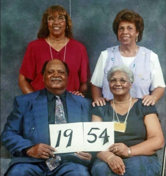 Members of the Class of 1954 hold up their class-year card at the 1999 Blevins reunion.