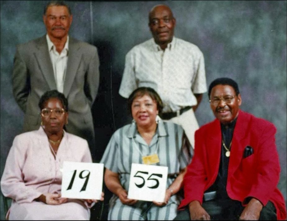 Members of the Class of 1955 hold up their class-year card at the 1999 Blevins reunion.