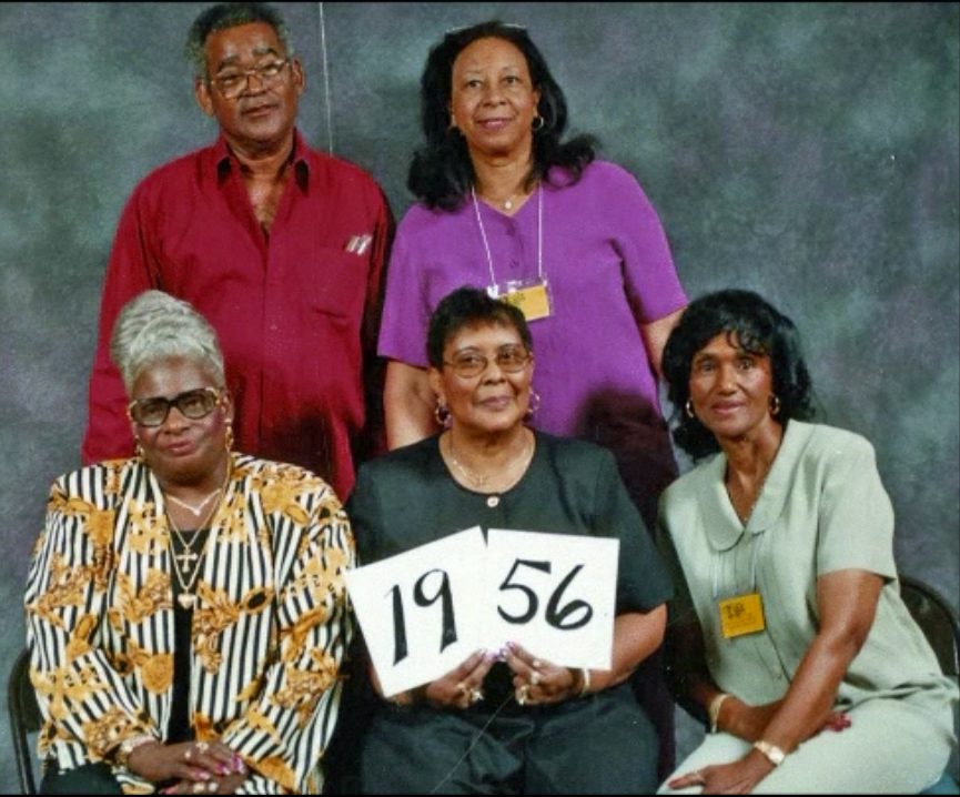 Members of the Class of 1956 hold up their class-year card at the 1999 Blevins reunion.