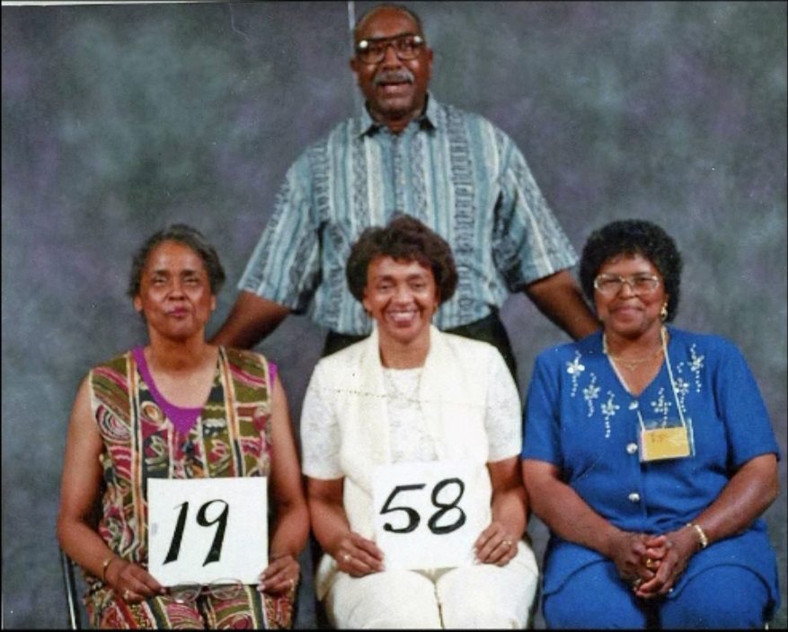 Members of the Class of 1958 hold up their class-year card at the 1999 Blevins reunion.