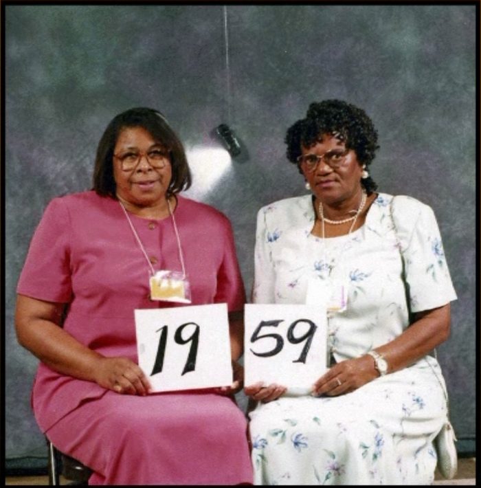 Members of the Class of 1959 hold up their class-year card at the 1999 Blevins reunion.