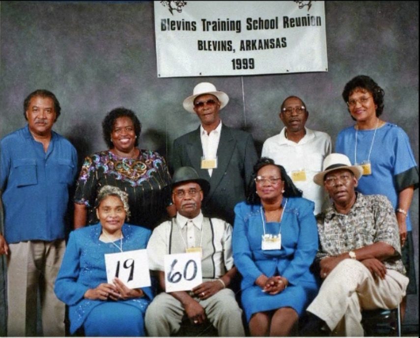 Members of the Class of 1960 hold up their class-year card at the 1999 Blevins reunion.