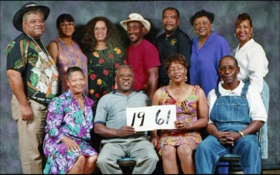 Members of the Class of 1961 hold up their class-year card at the 1999 Blevins reunion.