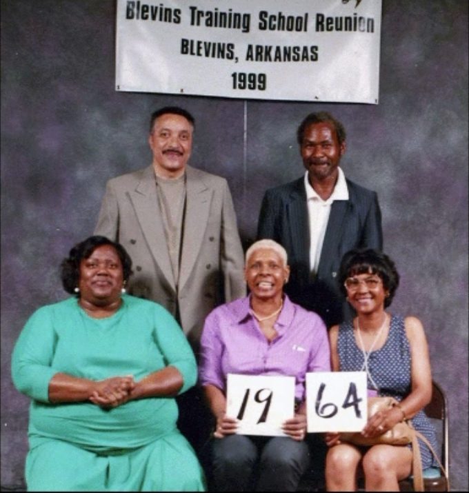 Members of the Class of 1964 hold up their class-year card at the 1999 Blevins reunion.