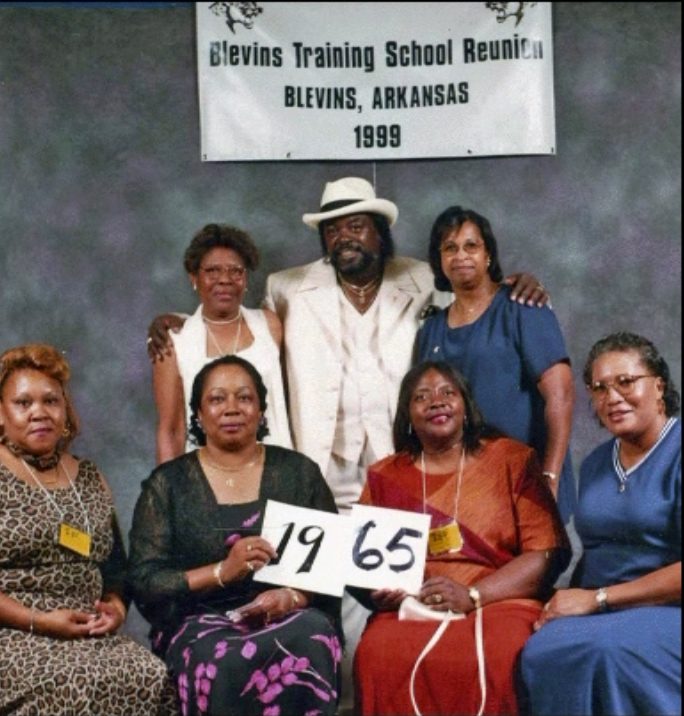 Members of the Class of 1965 hold up their class-year card at the 1999 Blevins reunion.