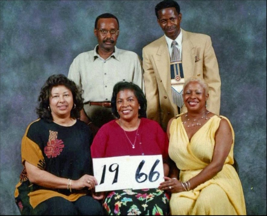 Members of the Class of 1966 hold up their class-year card at the 1999 Blevins reunion.