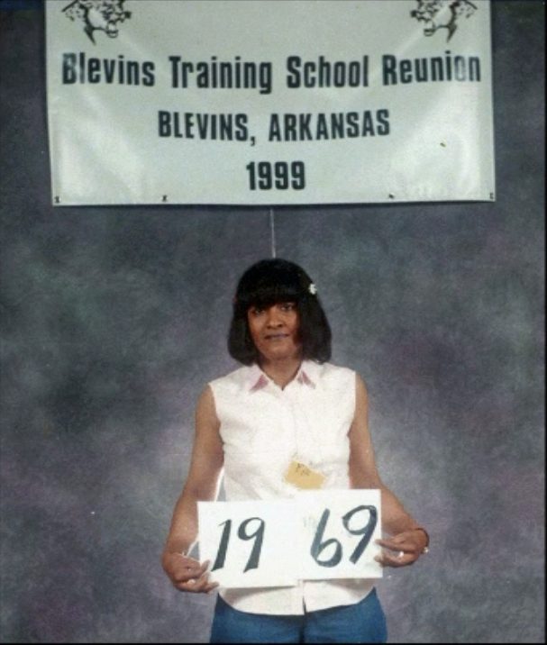 Members of the Class of 1969 hold up their class-year card at the 1999 Blevins reunion.